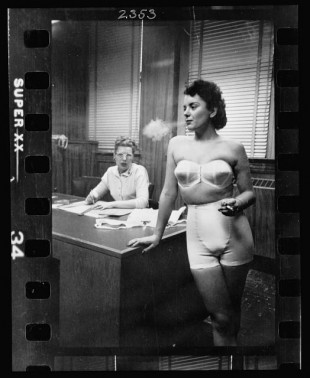 22.-Woman-model-standing-in-an-office-smoking-while-modeling-undergarments